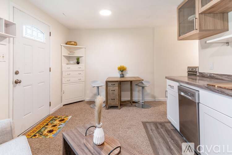 A kitchen with white appliances and a wooden island.