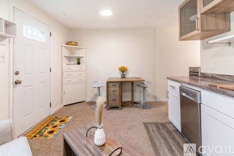 A kitchen with white appliances and a wooden island.