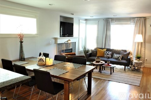 A modern living room with a dining table and chairs.