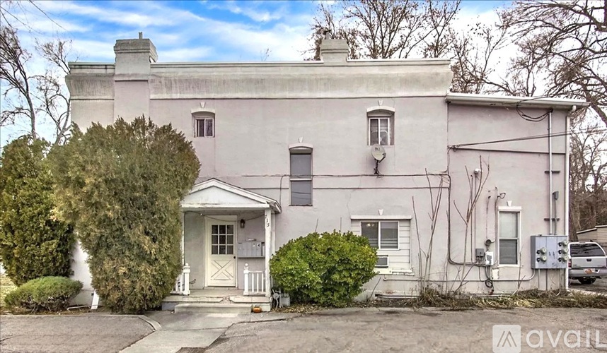 A house with a white door and windows is for sale.