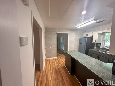A kitchen area with a counter and cabinets.