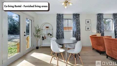 A co-living rental furnished living area with a dining table and chairs.