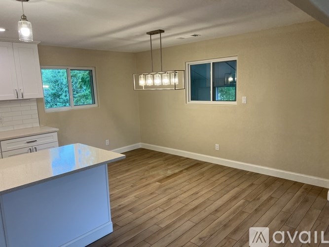 A kitchen with a counter and cabinets is available for rent.