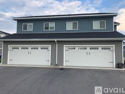 A two-car garage is attached to a house.