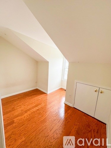 A room with wooden floors and white walls.