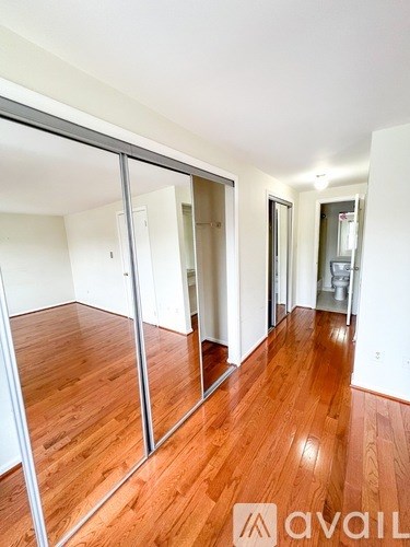 A room with wooden floors and a sliding glass door.
