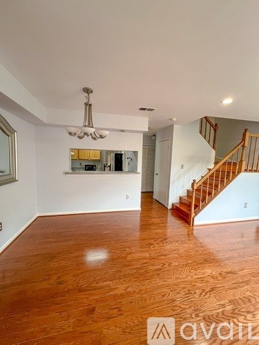 A room with wooden floors and a staircase.