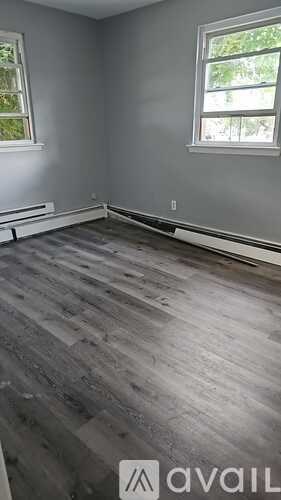A room with a grey floor and a window.
