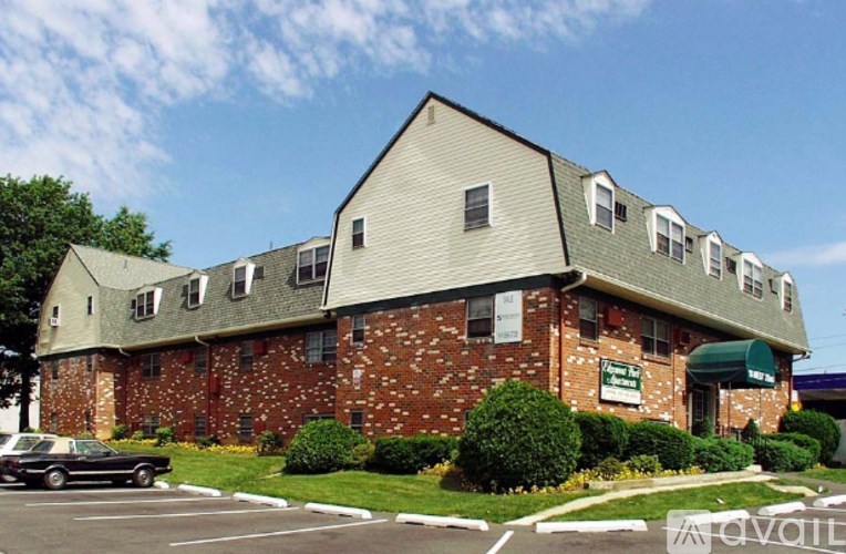 A building with a green awning and a sign that says "available" in front of it.