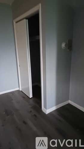 A room with a door and a wall socket.