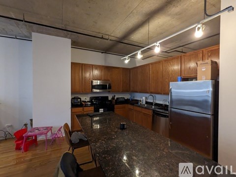 A kitchen with a granite countertop and stainless steel appliances.