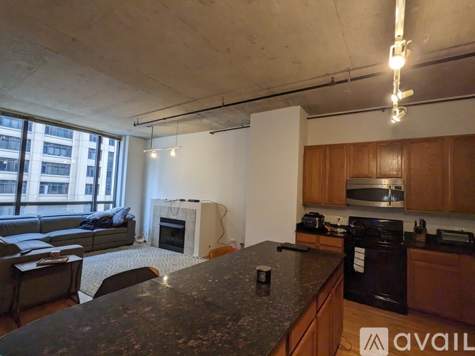 A kitchen with a black countertop and wooden cabinets.