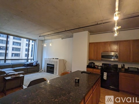 A kitchen with a black countertop and wooden cabinets.