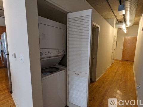 A kitchen with a washing machine and a dryer in it.