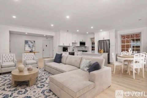 A modern living room with a white sofa and a coffee table.