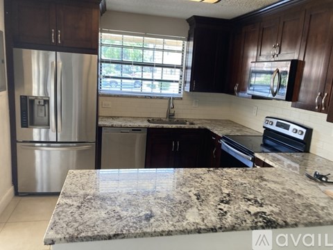 A kitchen with granite countertops and stainless steel appliances.