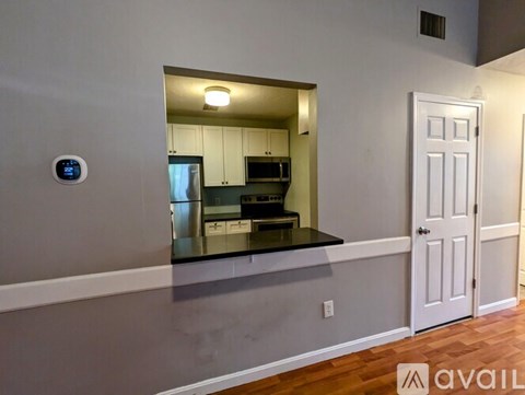A kitchen with a countertop and a view into the kitchen.