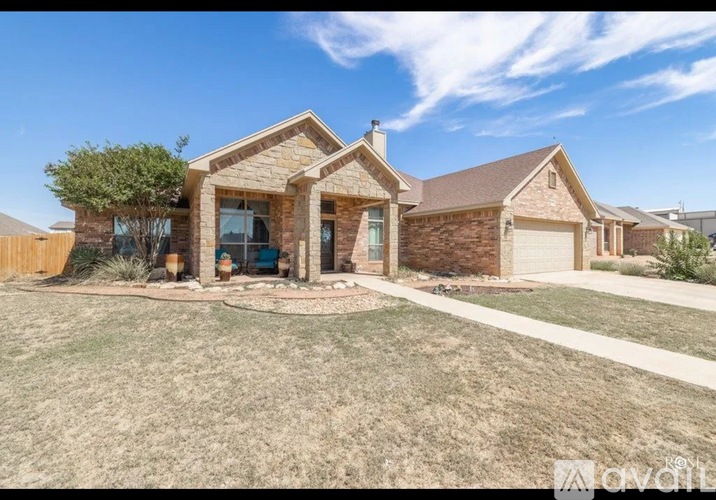 A house with a front yard and a driveway.