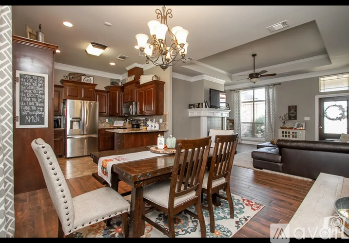 A well-furnished kitchen and dining area with a wooden table and chairs.
