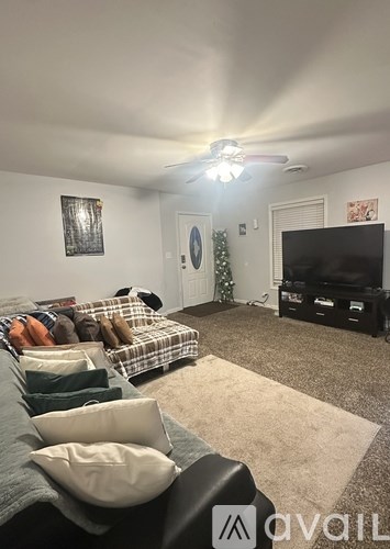 A living room with a grey couch and a television.