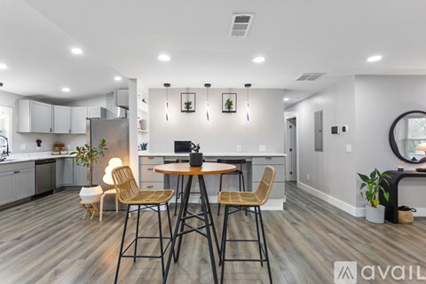 A modern kitchen with a dining table and chairs.