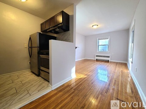 A kitchen area with a microwave, oven, and a window.