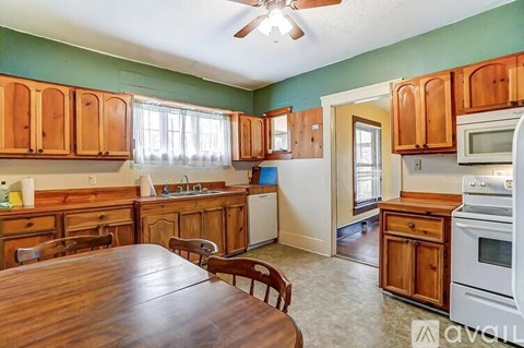 A kitchen with wooden cabinets and a table.