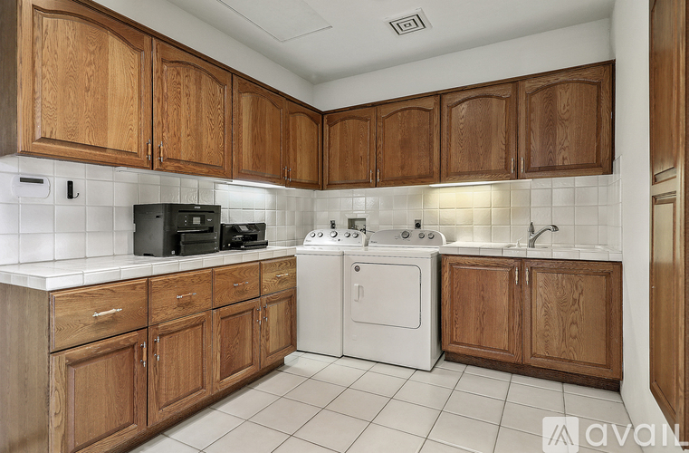 A kitchen with wooden cabinets and white appliances.