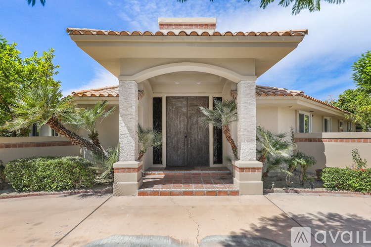 A house with a covered entrance and a small porch.