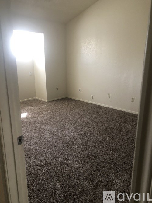 A room with carpeted floor and white walls.
