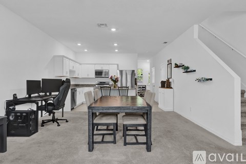 A modern living room with a dining table and chairs.