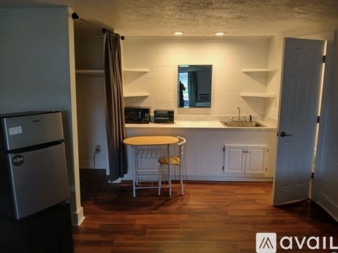 A kitchen with a table and chairs in the middle of the room.