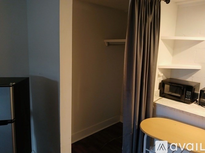 A small kitchen with a microwave and oven on a counter.