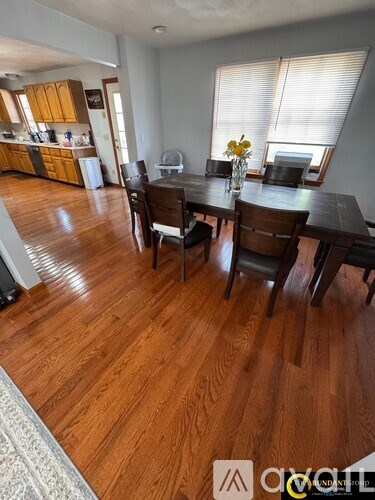 A dining room with a table and chairs.