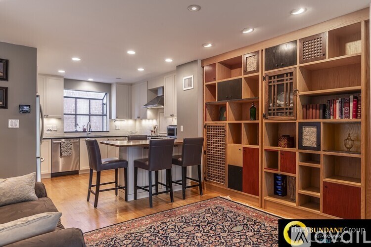 A kitchen with a dining table and chairs in the middle of the room.