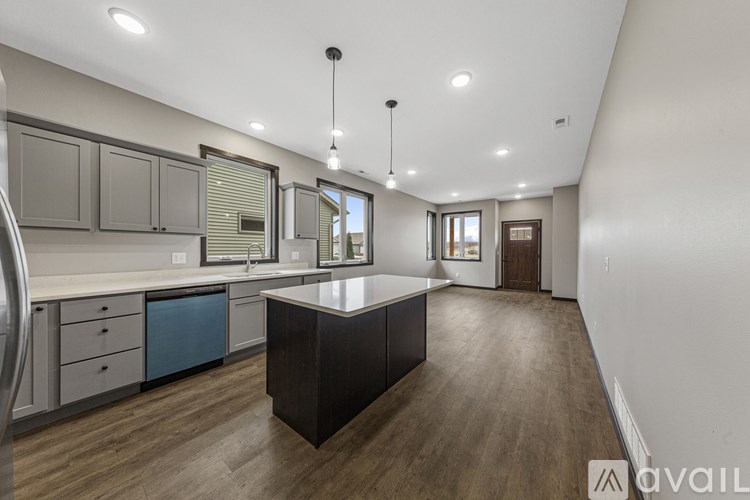 A modern kitchen with a large island in the middle.