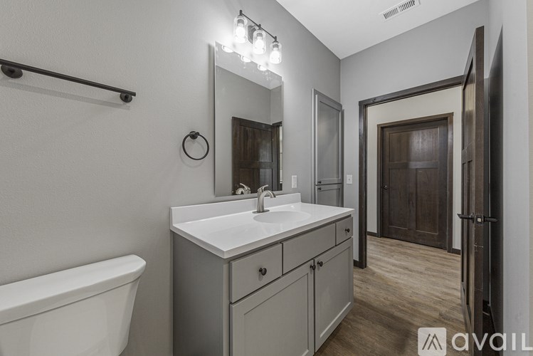 A bathroom with a white sink and a white bathtub.