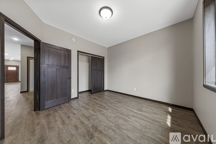 A room with wooden floors and a large window.