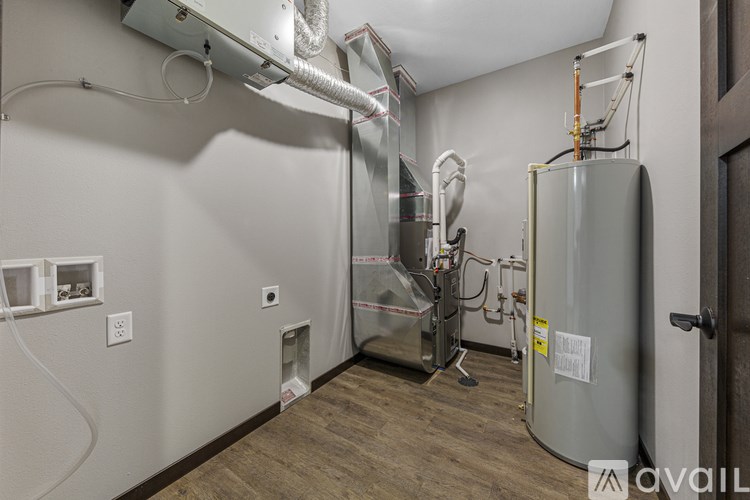 A room with a large metal tank and pipes.