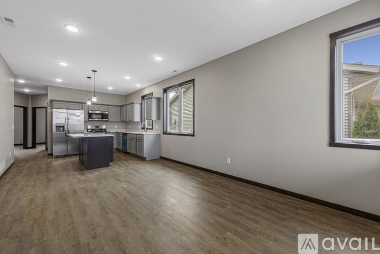 A spacious kitchen with a dining area and a large window.