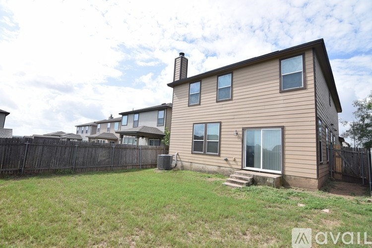 A house with a fence and a grassy yard.