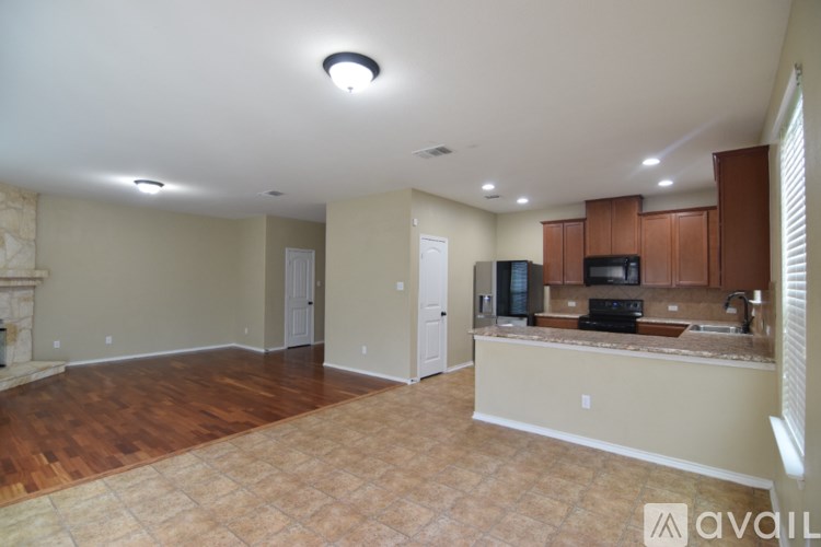 A backyard with a wooden fence and a concrete slab.