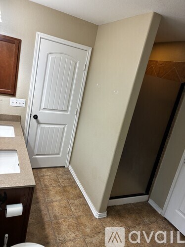 A white door is in a room with a brown floor.