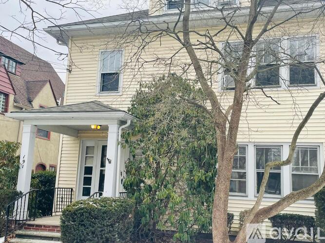 A house with a white front door and a porch.