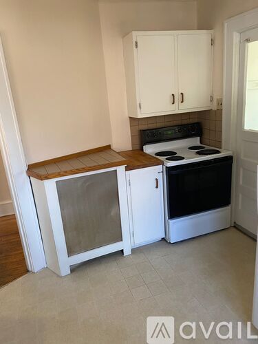 A kitchen with a stove and cabinets.