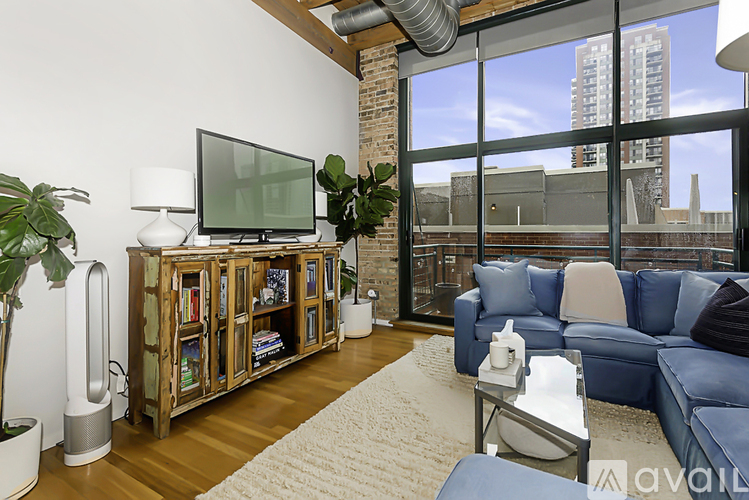 A living room with a blue couch and a television on a wooden stand.