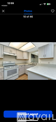 A kitchen with white cabinets and a countertop.