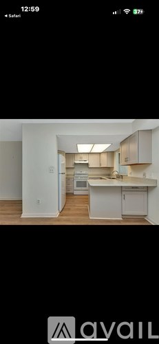 A kitchen with white cabinets and a countertop.