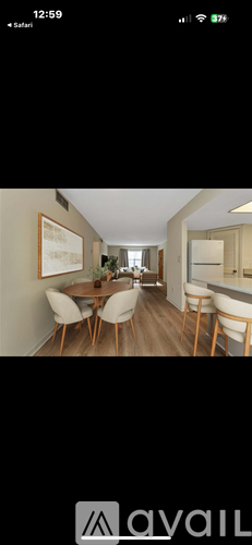 A dining room with a table and chairs.