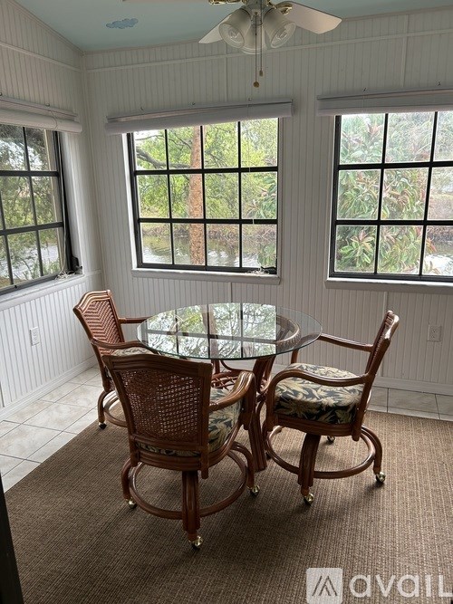 A dining room with a glass table and chairs.